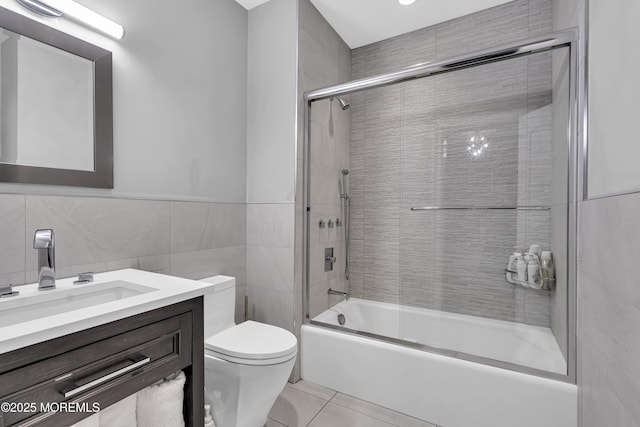 5 Champlain Ct, Lakewood, NJ 08701 - bathroom with tile walls, vanity, enclosed tub / shower combo, tile patterned flooring, and a wainscoted wall