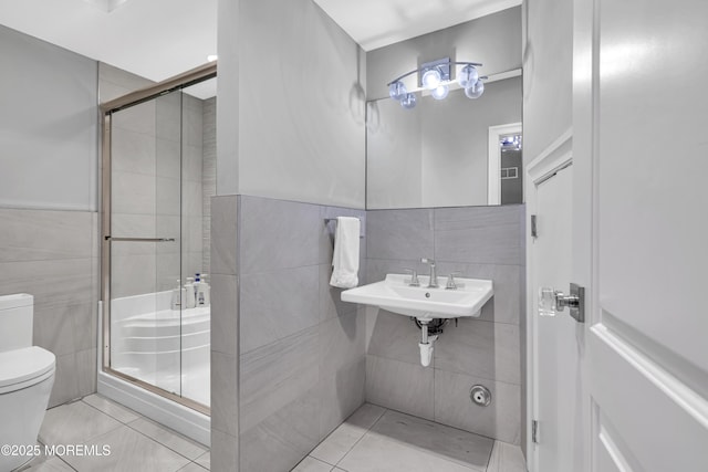 5 Champlain Ct, Lakewood, NJ 08701 - bathroom featuring tile walls, a shower stall, tile patterned flooring, and a wainscoted wall