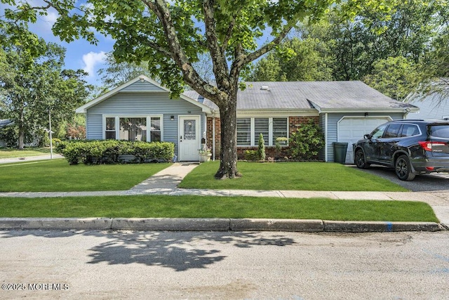 58 Hedge Dr, Lakewood, NJ 08701 - view of front of home featuring a garage, a front yard, brick siding, and driveway