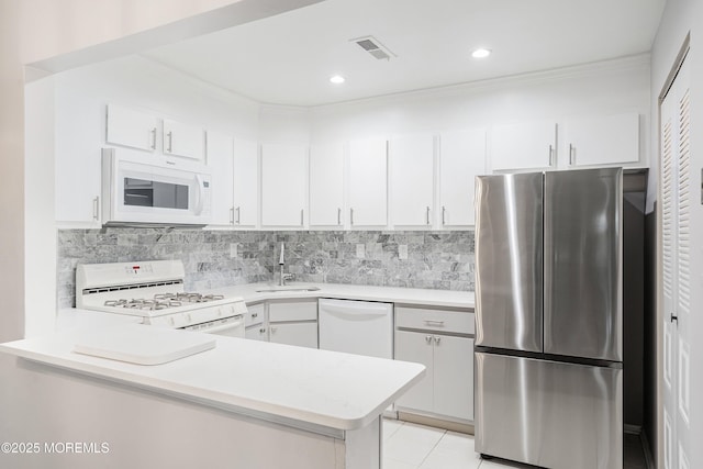 33 Honeysuckle Ln Unit 194, Red Bank, NJ 07701 - kitchen with white appliances, light countertops, a peninsula, white cabinetry, and backsplash
