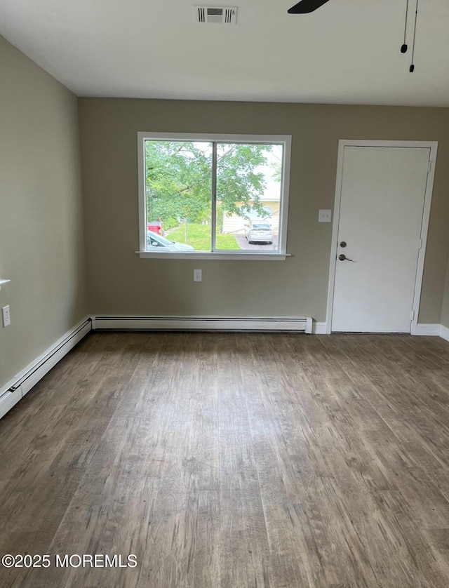 101 Bonaire Dr, Toms River, NJ 08757 - unfurnished living room featuring wood finished floors, ceiling fan, and a baseboard radiator
