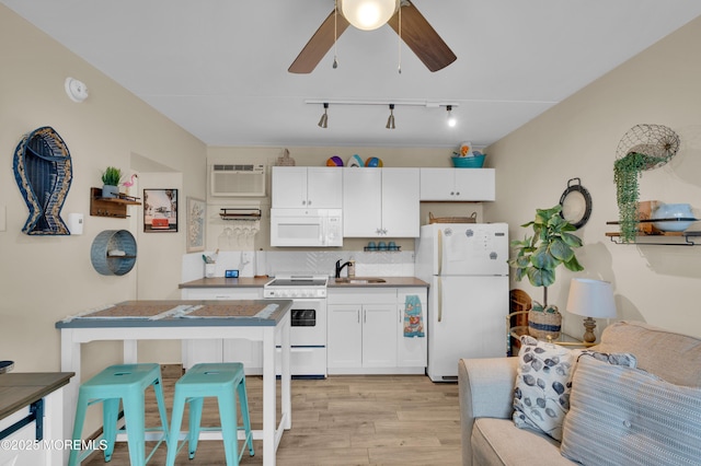 1515 Boulevard Blvd Unit 24, Seaside Heights, NJ 08751 - kitchen featuring white appliances, rail lighting, an AC wall unit, light wood finished floors, and a ceiling fan