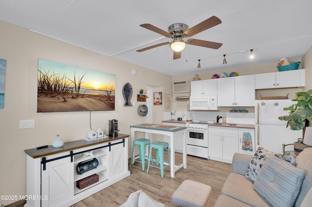 1515 Boulevard Blvd Unit 24, Seaside Heights, NJ 08751 - kitchen with white appliances, a ceiling fan, white cabinetry, light wood-style flooring, and rail lighting