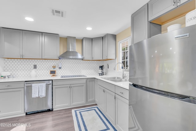 200 Ceylon Ave, Seaside Heights, NJ 08751 - kitchen featuring appliances with stainless steel finishes, wall chimney exhaust hood, gray cabinets, decorative backsplash, and light countertops