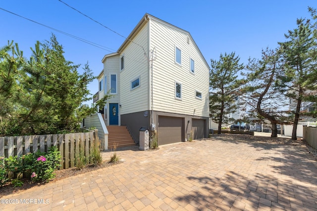 208 E 20th St, Long Beach Twp, NJ 08008 - view of property exterior with a garage and decorative driveway