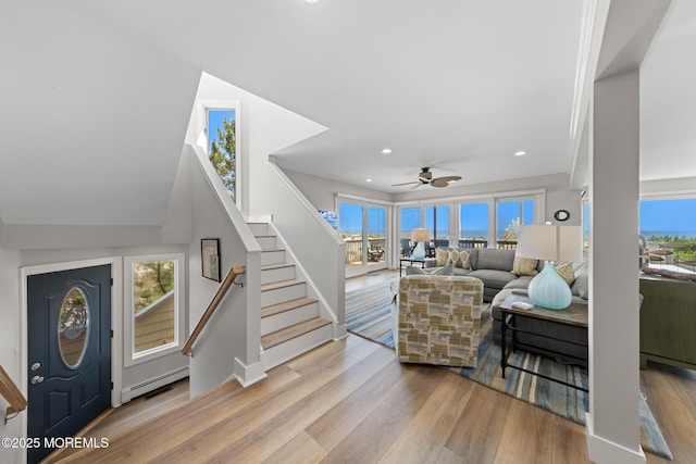 208 E 20th St, Long Beach Twp, NJ 08008 - living area with baseboard heating, stairs, wood finished floors, plenty of natural light, and recessed lighting