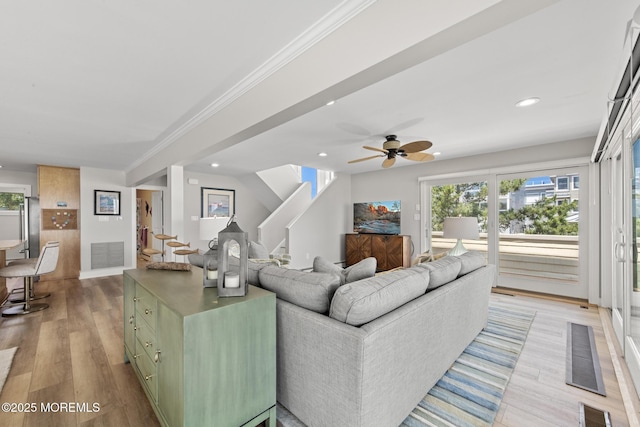 208 E 20th St, Long Beach Twp, NJ 08008 - living area featuring recessed lighting, plenty of natural light, ornamental molding, stairs, and light wood-style floors