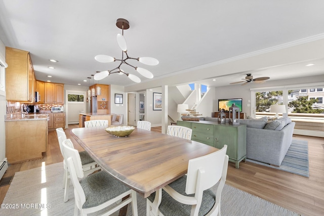 208 E 20th St, Long Beach Twp, NJ 08008 - dining room with stairway, light wood finished floors, recessed lighting, a chandelier, and ornamental molding