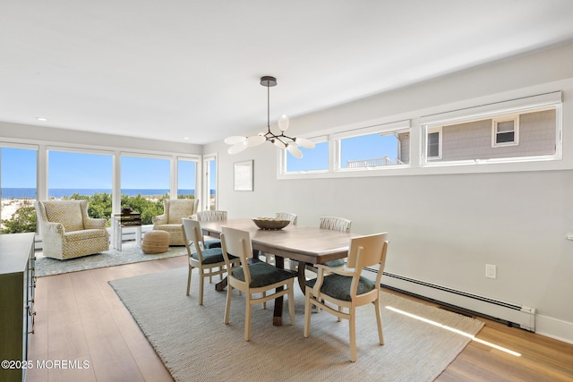 208 E 20th St, Long Beach Twp, NJ 08008 - dining room with a baseboard radiator, a chandelier, light wood-style floors, and recessed lighting