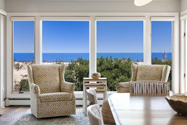 208 E 20th St, Long Beach Twp, NJ 08008 - sunroom with a baseboard radiator, a water view, and wood finished floors