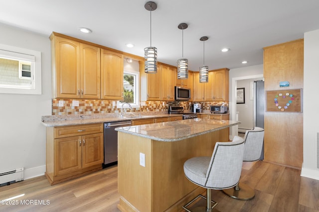 208 E 20th St, Long Beach Twp, NJ 08008 - kitchen with stainless steel appliances, light wood finished floors, light stone countertops, a center island, and recessed lighting