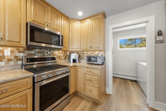 208 E 20th St, Long Beach Twp, NJ 08008 - kitchen with appliances with stainless steel finishes, baseboard heating, light brown cabinets, light wood-style floors, and backsplash