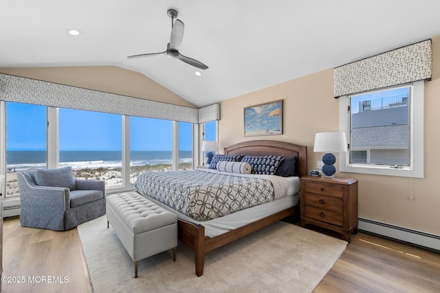 208 E 20th St, Long Beach Twp, NJ 08008 - bedroom featuring wood finished floors, multiple windows, baseboard heating, lofted ceiling, and a water view