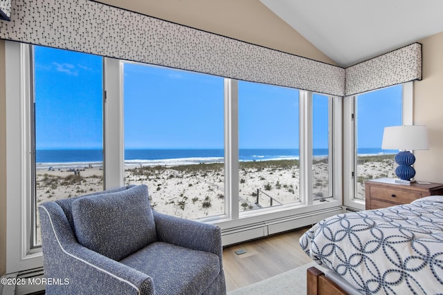 208 E 20th St, Long Beach Twp, NJ 08008 - bedroom featuring wood finished floors, baseboard heating, view of water and beach, vaulted ceiling, and radiator heating unit