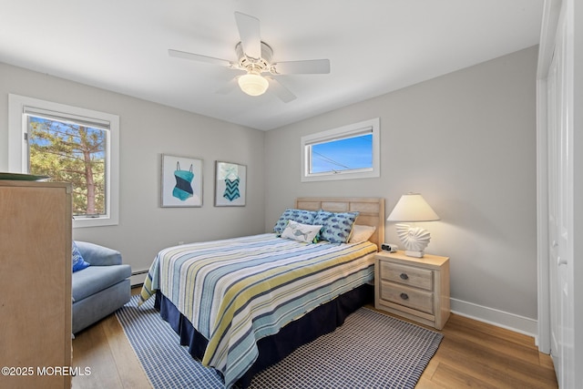 208 E 20th St, Long Beach Twp, NJ 08008 - bedroom with wood finished floors, multiple windows, and a ceiling fan