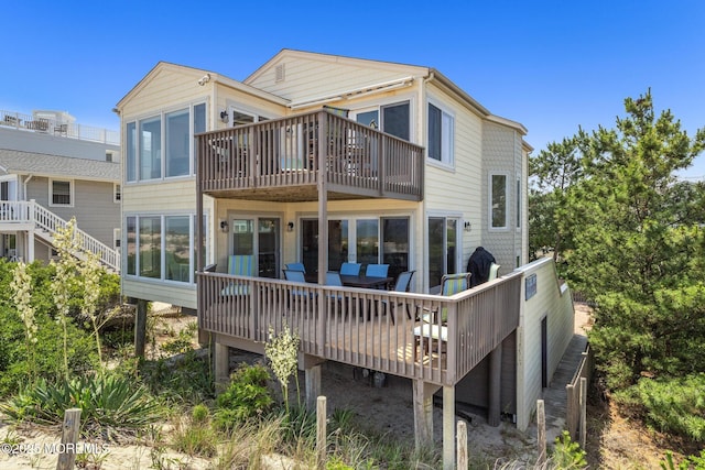 208 E 20th St, Long Beach Twp, NJ 08008 - back of property featuring a balcony and a wooden deck