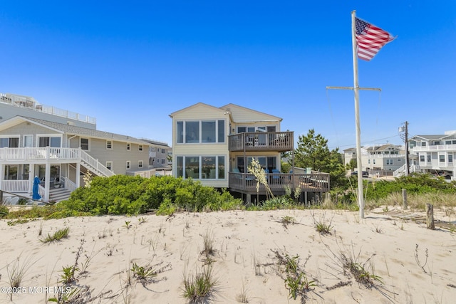 208 E 20th St, Long Beach Twp, NJ 08008 - rear view of house with a deck and a balcony