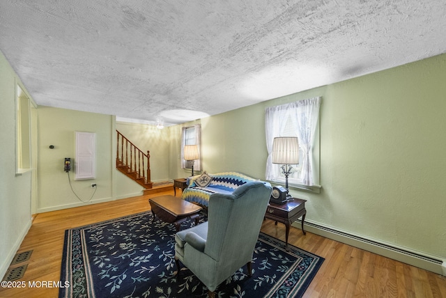 17 Wood Ave, Englishtown, NJ 07726 - living area with a baseboard radiator, stairs, wood finished floors, and a textured ceiling