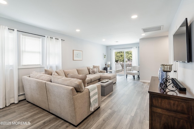 9 Maniwaki Ct, Toms River, NJ 08757 - living area with a baseboard heating unit, light wood-style floors, and recessed lighting