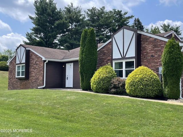 14 Weston Ct, Marlboro, NJ 07746 - tudor home with brick siding, a front lawn, and a shingled roof