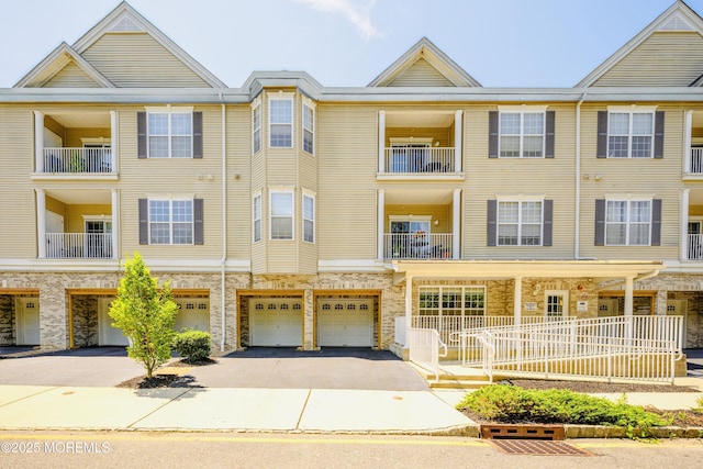 203 Canterbury Ln, Morganville, NJ 07751 - view of building exterior featuring driveway and an attached garage