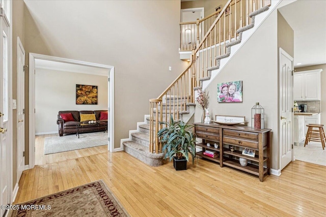 140 Palisade Dr, Freehold, NJ 07728 - entryway featuring hardwood / wood-style flooring, stairs, and a towering ceiling