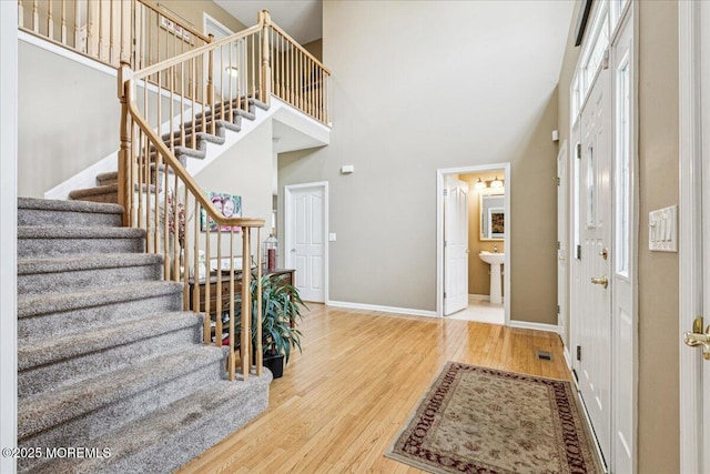 140 Palisade Dr, Freehold, NJ 07728 - entrance foyer featuring a high ceiling, stairway, and wood finished floors