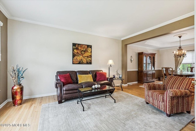 140 Palisade Dr, Freehold, NJ 07728 - living room with light wood-style floors, a chandelier, and crown molding