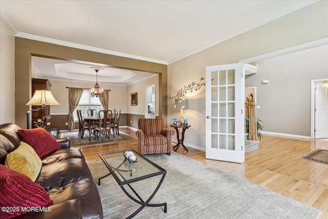 140 Palisade Dr, Freehold, NJ 07728 - living room with wood finished floors, a chandelier, crown molding, and a raised ceiling
