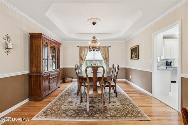 140 Palisade Dr, Freehold, NJ 07728 - dining room featuring a chandelier, light wood-type flooring, and a raised ceiling