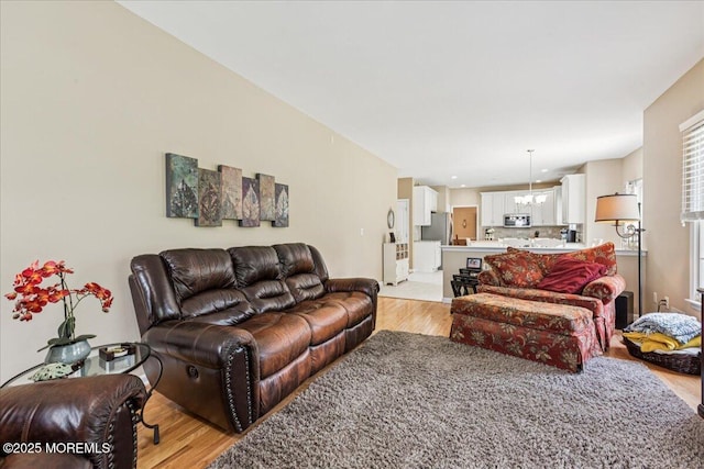 140 Palisade Dr, Freehold, NJ 07728 - living area with light wood-type flooring and a chandelier