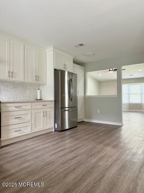 11 Ivy Rdg Unit 1000, Howell, NJ 07728 - kitchen featuring freestanding refrigerator, light wood finished floors, white cabinetry, decorative backsplash, and light countertops