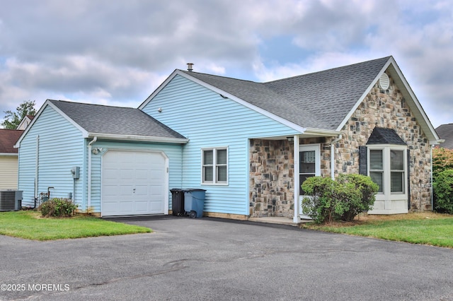 11 Ivy Rdg Unit 1000, Howell, NJ 07728 - view of front facade with stone siding, an attached garage, driveway, and roof with shingles