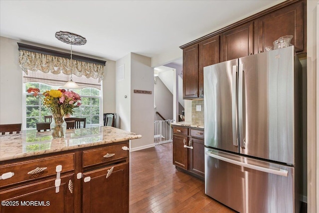 259 Chickadee Ct Unit 1000, Freehold, NJ 07728 - kitchen with freestanding refrigerator, light stone counters, pendant lighting, dark wood finished floors, and backsplash