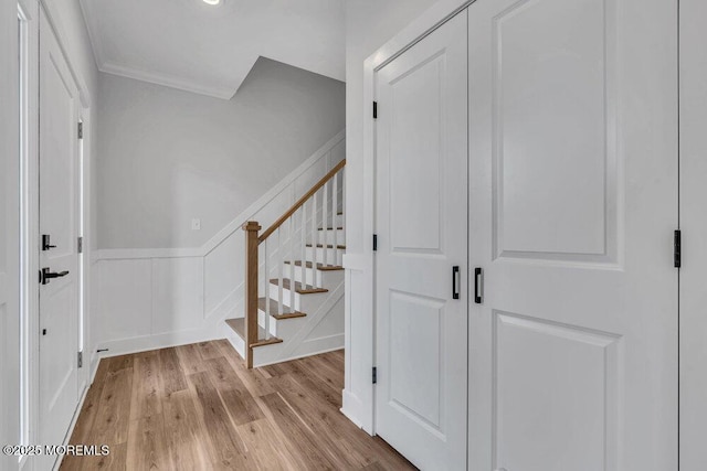 12 Outsail Ave, Barnegat, NJ 08005 - stairs with wood finished floors, crown molding, a wainscoted wall, and a decorative wall