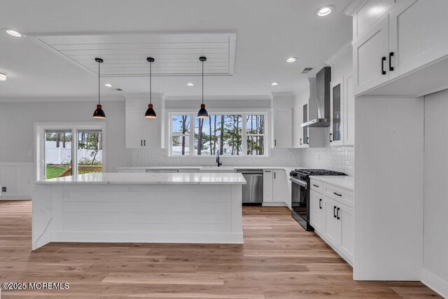 12 Outsail Ave, Barnegat, NJ 08005 - kitchen featuring gas stove, dishwasher, wall chimney exhaust hood, ornamental molding, and white cabinetry