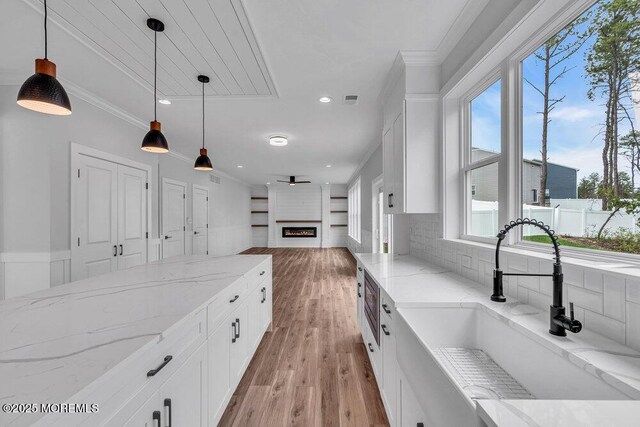 12 Outsail Ave, Barnegat, NJ 08005 - kitchen featuring white cabinets, hanging light fixtures, a ceiling fan, light wood-type flooring, and ornamental molding
