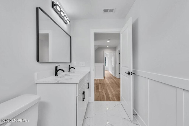 12 Outsail Ave, Barnegat, NJ 08005 - bathroom with marble finish floors, double vanity, wainscoting, and a decorative wall