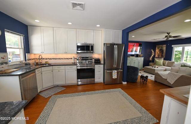 244D Jefferson Ct, Lakewood, NJ 08701 - kitchen featuring stainless steel appliances, dark countertops, dark wood finished floors, white cabinetry, and recessed lighting