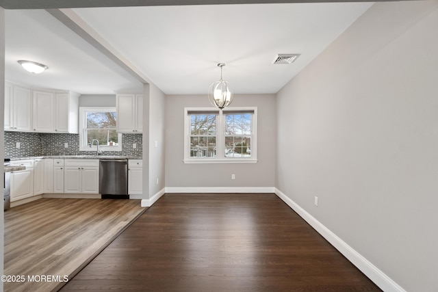 23 Island Dr, Brick, NJ 08724 - kitchen with dishwasher, backsplash, a chandelier, wood finished floors, and white cabinets