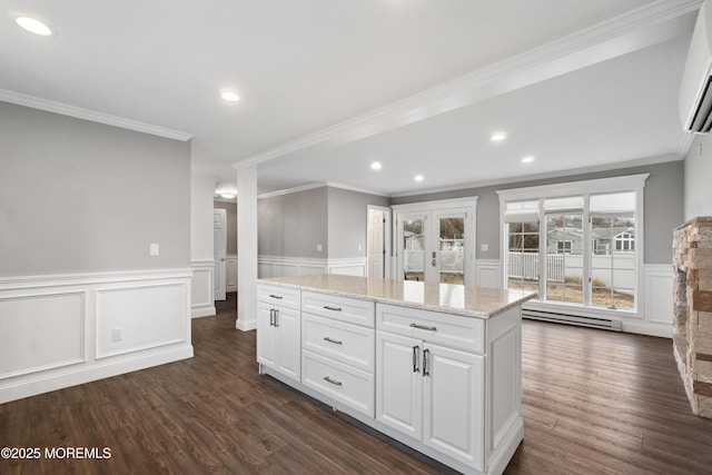 23 Island Dr, Brick, NJ 08724 - kitchen with dark wood finished floors, white cabinets, ornamental molding, light stone counters, and recessed lighting