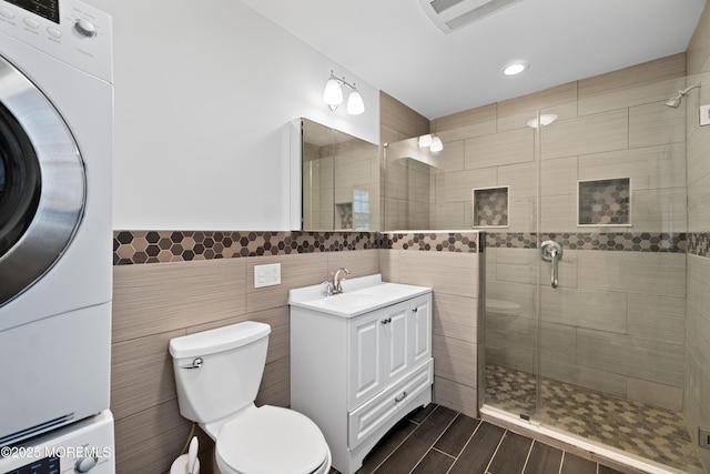 23 Island Dr, Brick, NJ 08724 - bathroom with tile walls, vanity, stacked washer / dryer, a shower stall, and recessed lighting