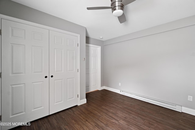 23 Island Dr, Brick, NJ 08724 - unfurnished bedroom featuring a baseboard heating unit, dark wood finished floors, a closet, and a ceiling fan