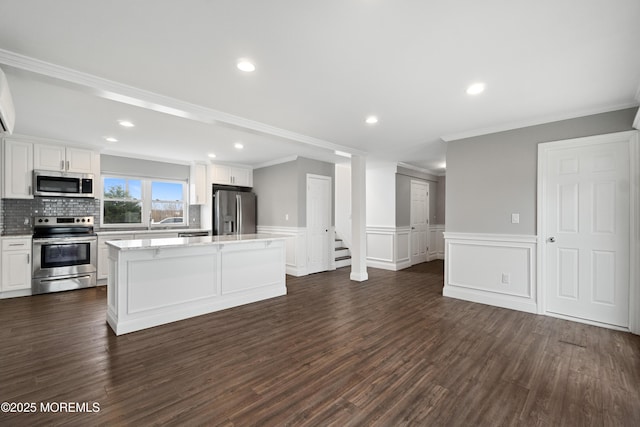 23 Island Dr, Brick, NJ 08724 - kitchen featuring stainless steel appliances, ornamental molding, a center island, white cabinets, and dark wood finished floors