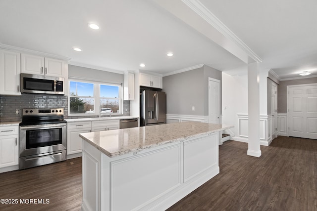 23 Island Dr, Brick, NJ 08724 - kitchen featuring stainless steel appliances, white cabinetry, ornamental molding, dark wood-type flooring, and tasteful backsplash