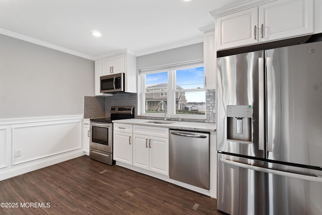 23 Island Dr, Brick, NJ 08724 - kitchen with stainless steel appliances, crown molding, dark wood-type flooring, white cabinets, and tasteful backsplash