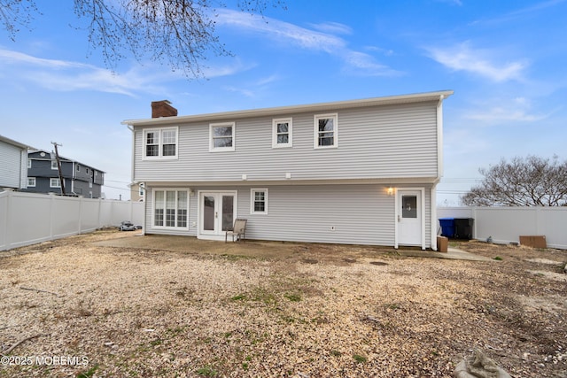 23 Island Dr, Brick, NJ 08724 - rear view of property featuring french doors, a chimney, and a fenced backyard