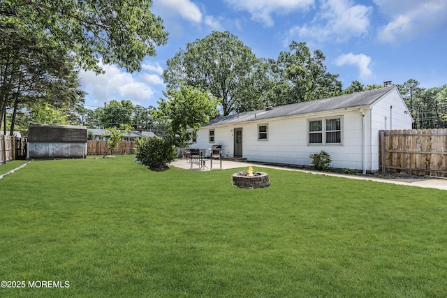 1341 1st Ave, Toms River, NJ 08757 - rear view of house featuring an outdoor fire pit, a fenced backyard, a shed, and a patio