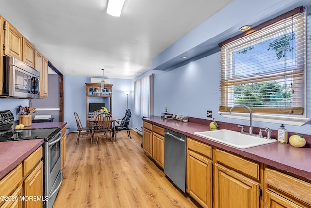 1341 1st Ave, Toms River, NJ 08757 - kitchen with stainless steel appliances, light wood-type flooring, dark countertops, and hanging light fixtures