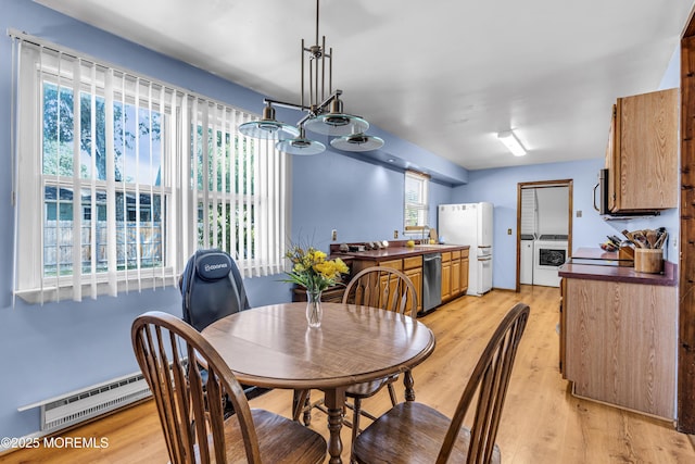 1341 1st Ave, Toms River, NJ 08757 - dining room with washing machine and clothes dryer, light wood-style floors, and a chandelier